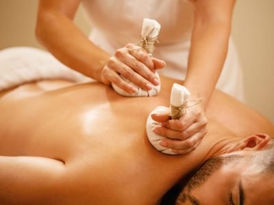 closeup-man-getting-back-massage-with-detox-herbal-balls-health-spa-min